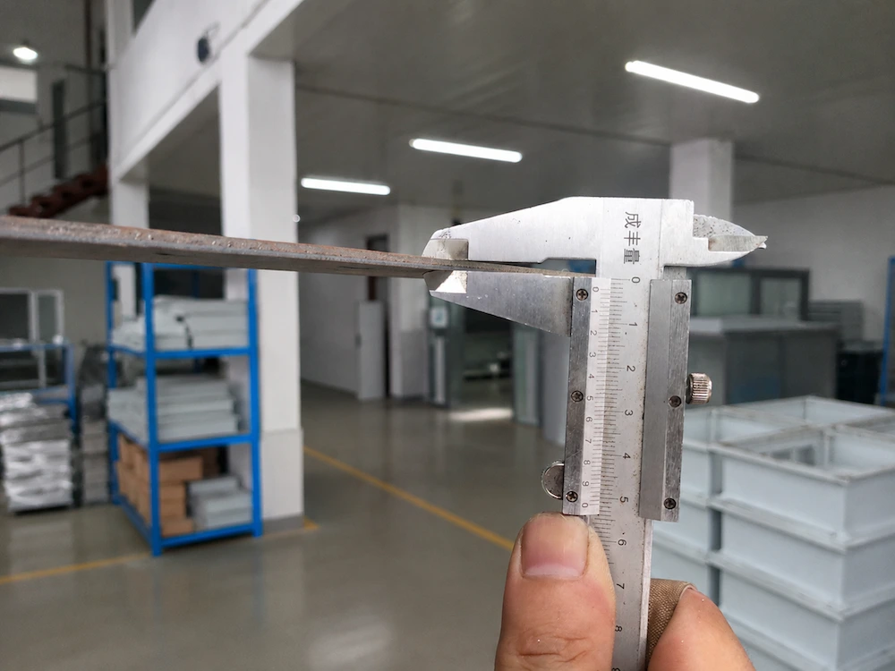 A caliper measuring a metal component in the workshop